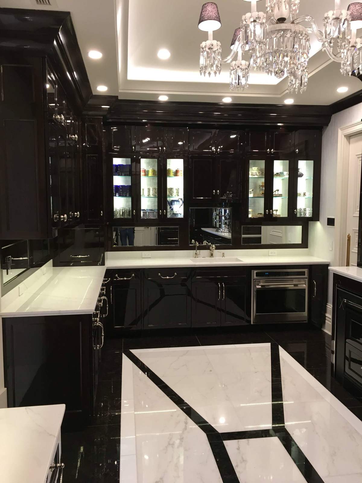 Black kitchen cabinetry with decorative glass doors