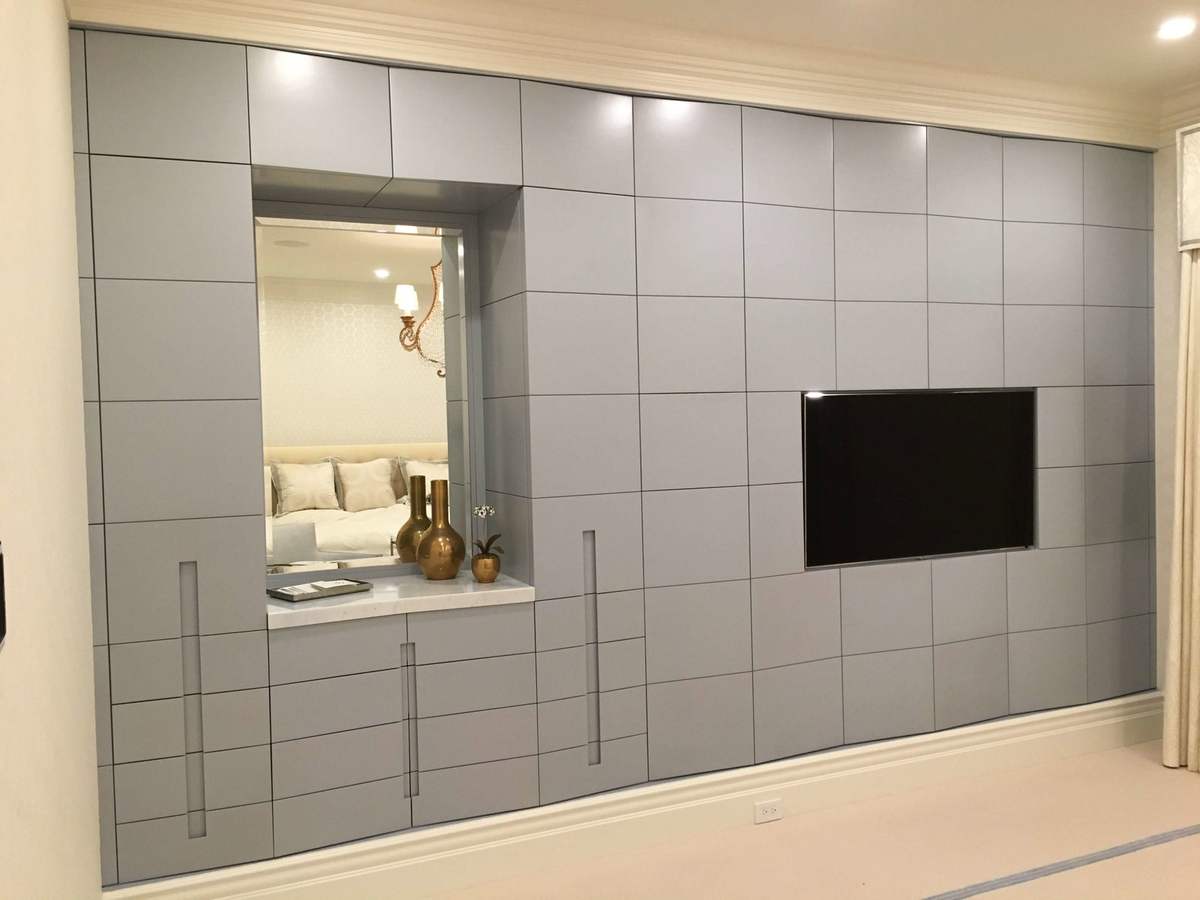 Paneled media wall with inset TV and display niche