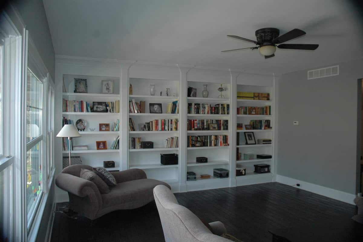 Living room with wall of white built-in bookshelves
