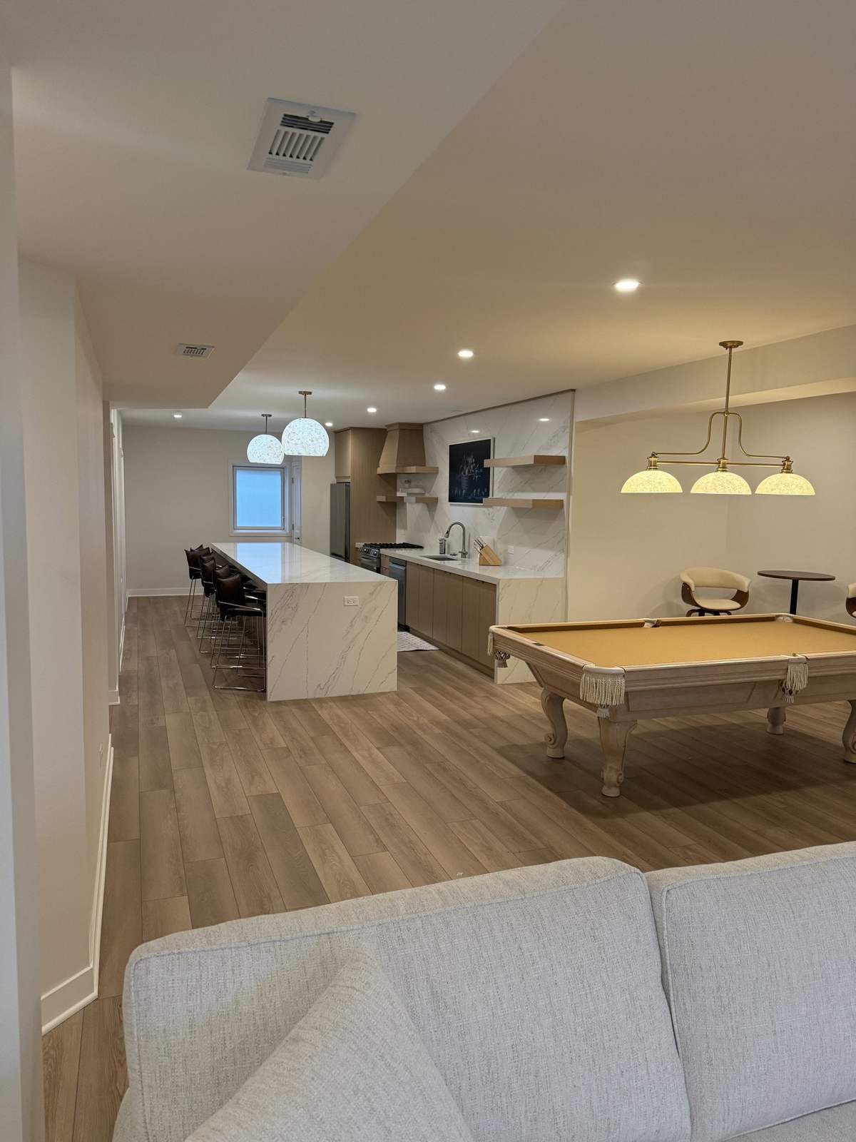 Finished basement with kitchenette and wood-look flooring