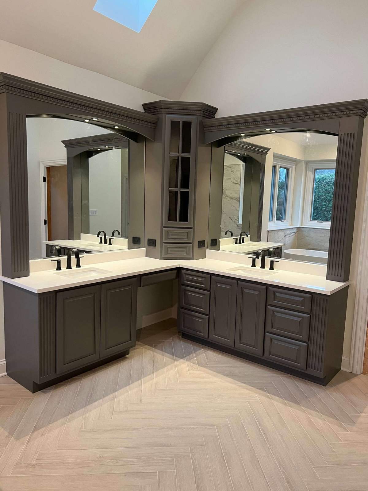 Remodeled double vanity with dark cabinets and large mirrors