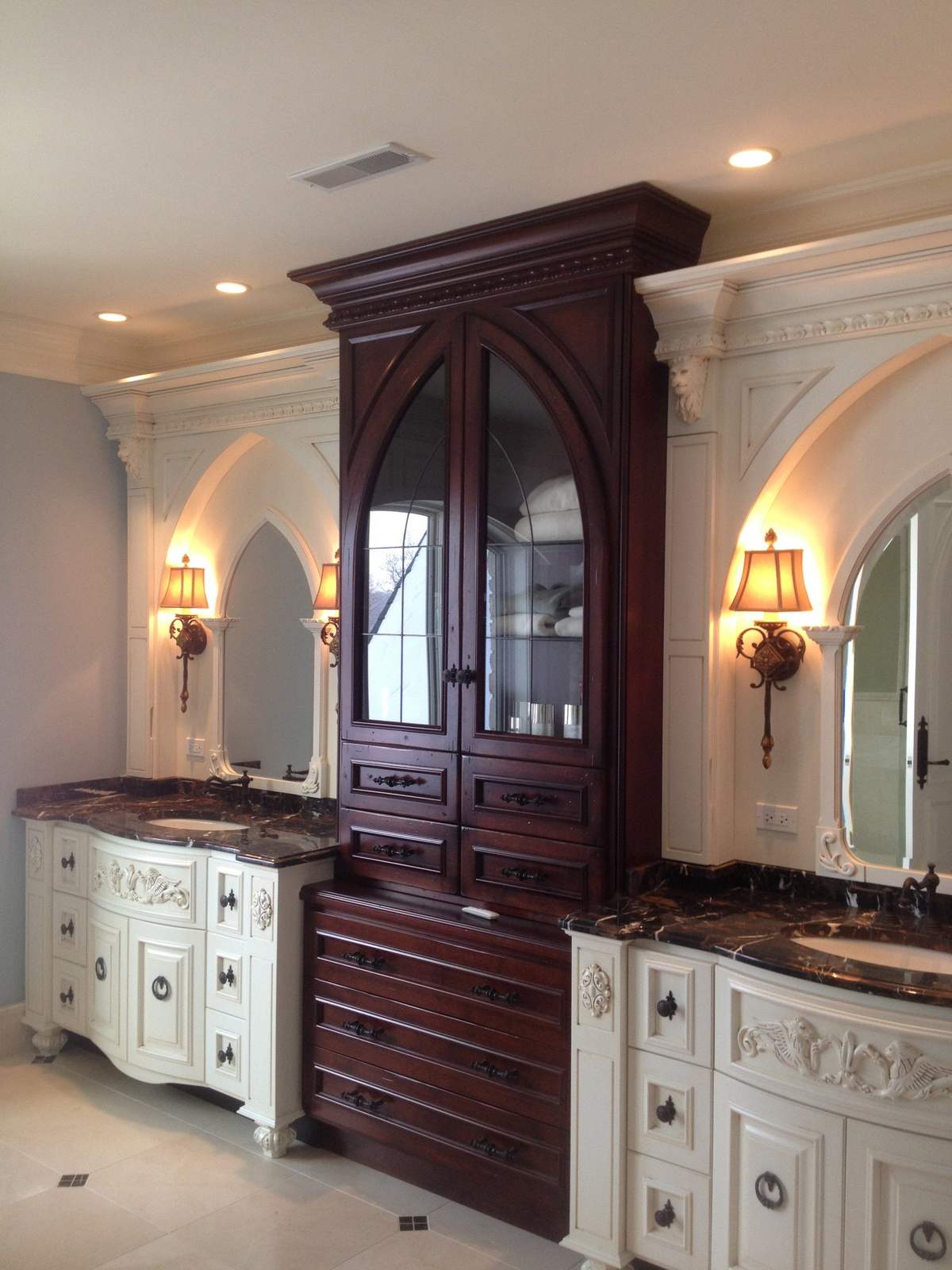 Bathroom cabinetry with a tall dark wood center cabinet