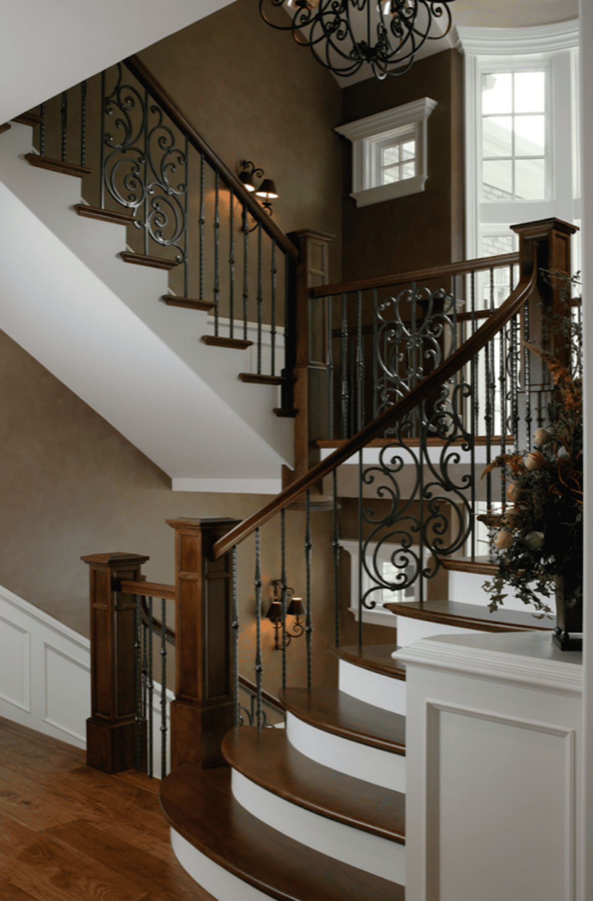 Wood staircase with decorative metal balusters