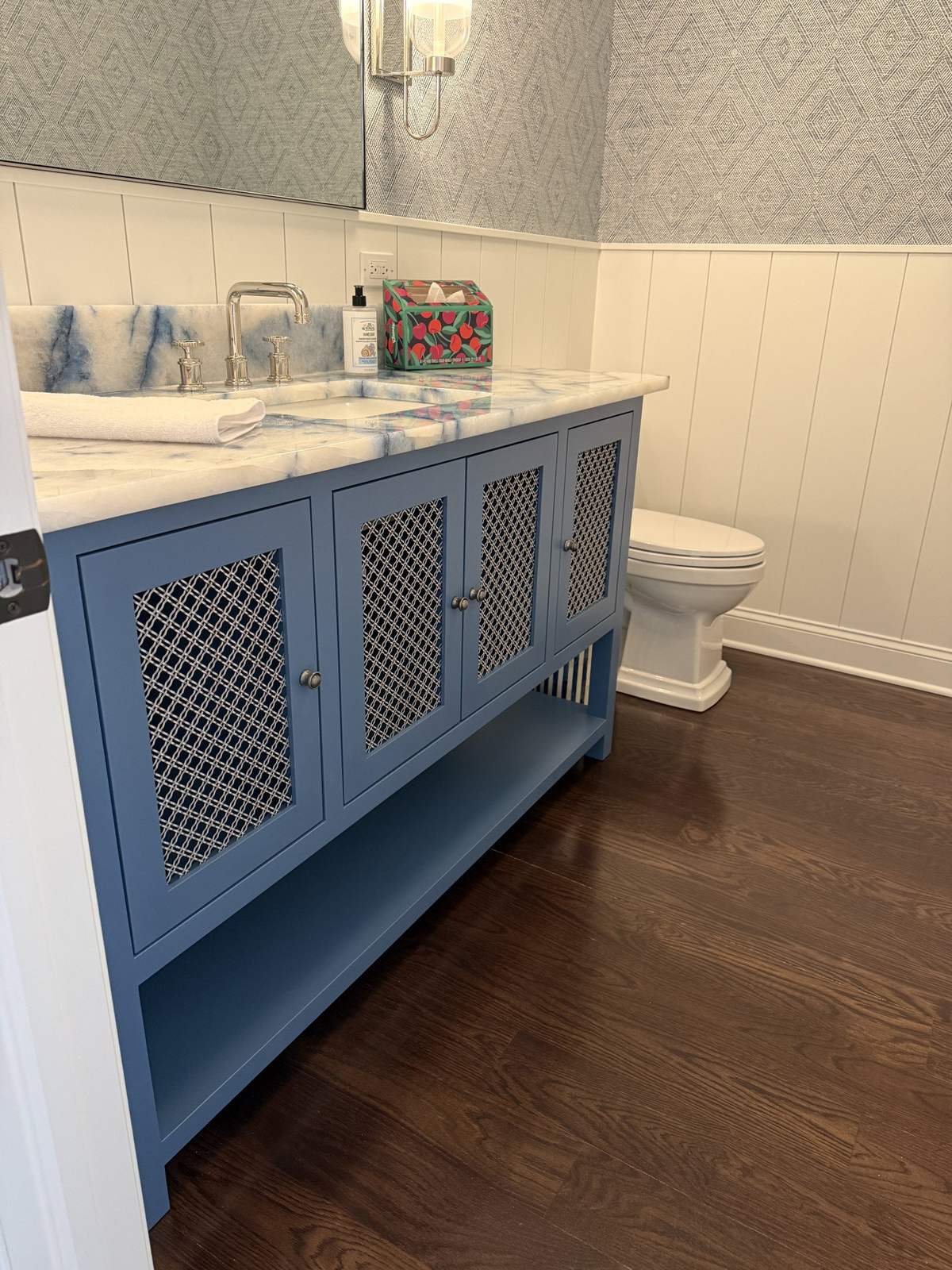 Blue double vanity with patterned cabinet doors