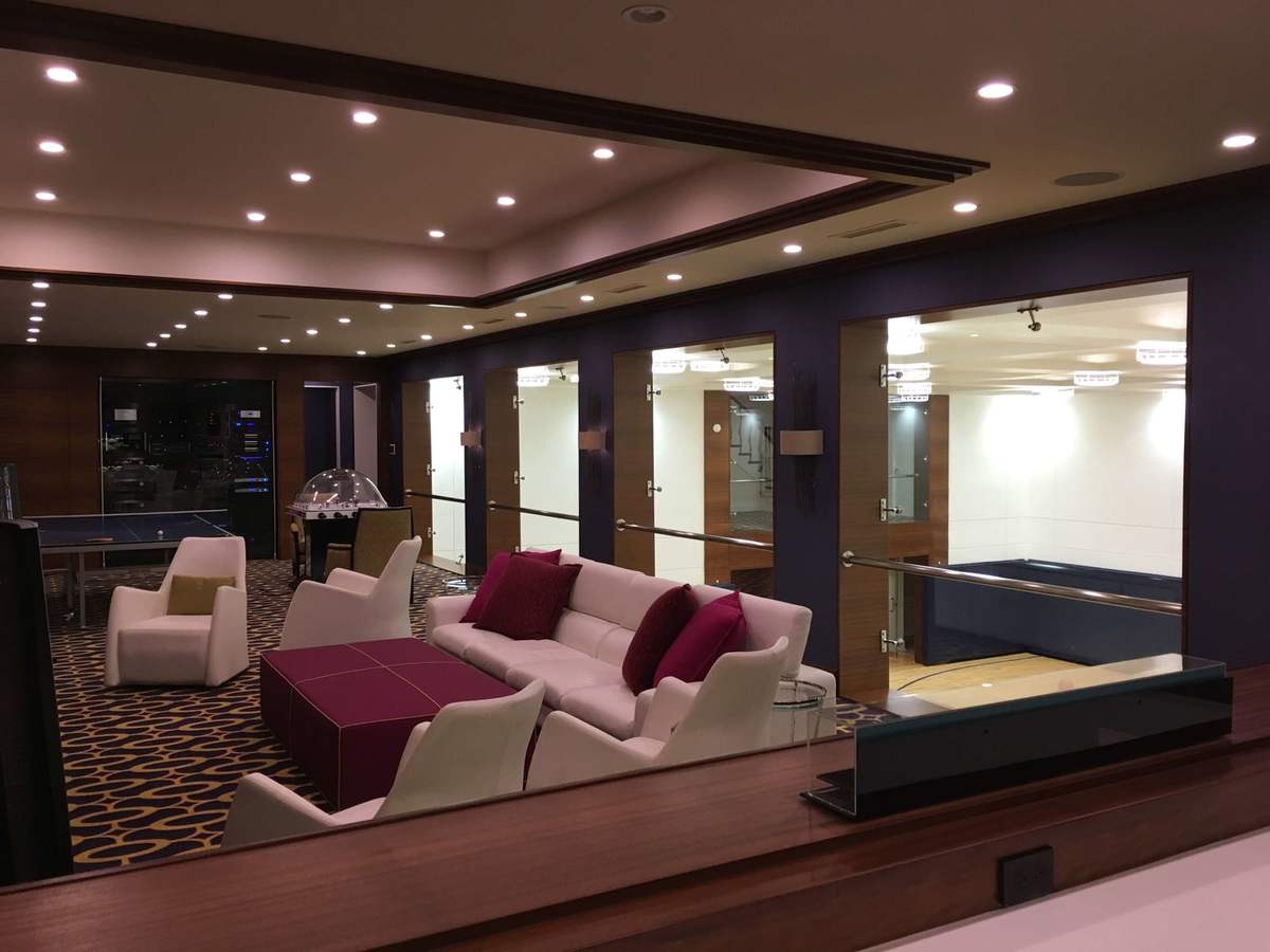 Finished basement seating area with recessed lighting