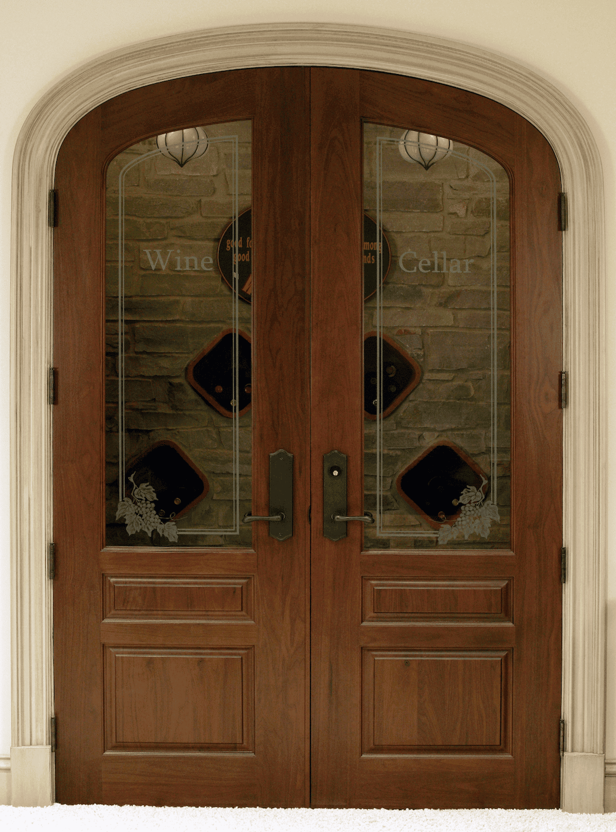 Arched wood double doors with decorative glass