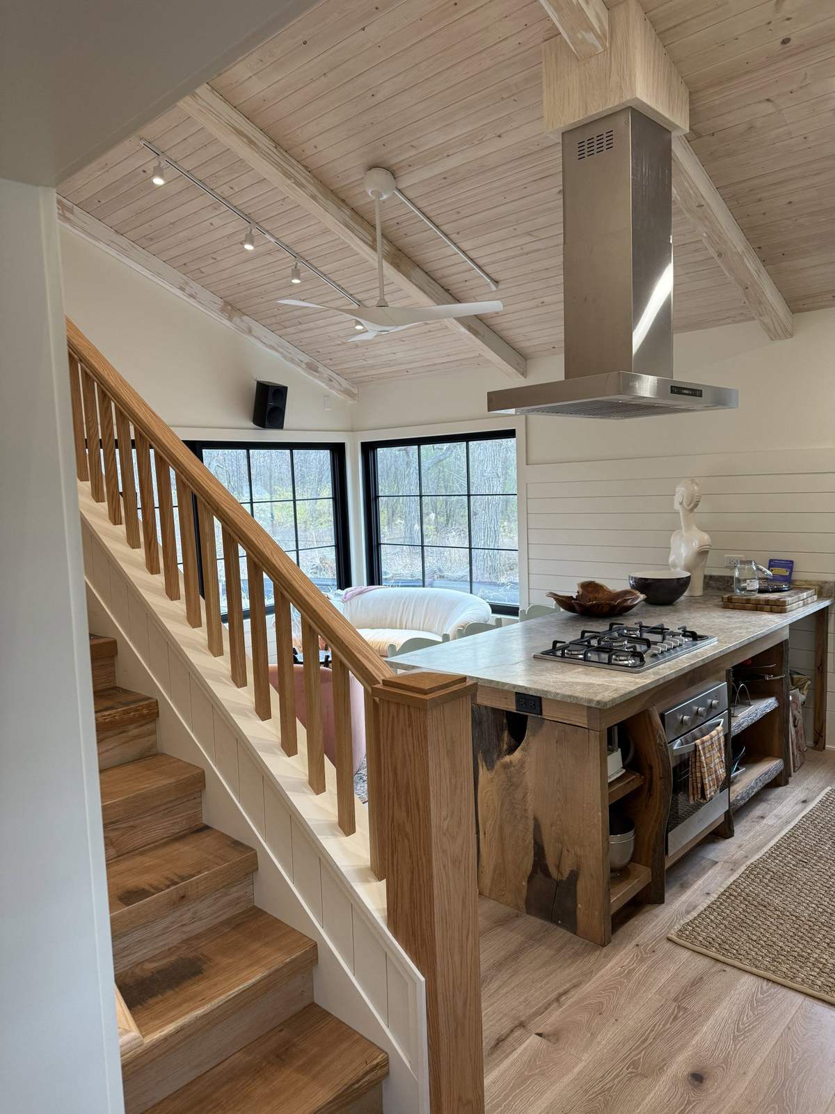 Kitchen island beneath exposed white ceiling beams