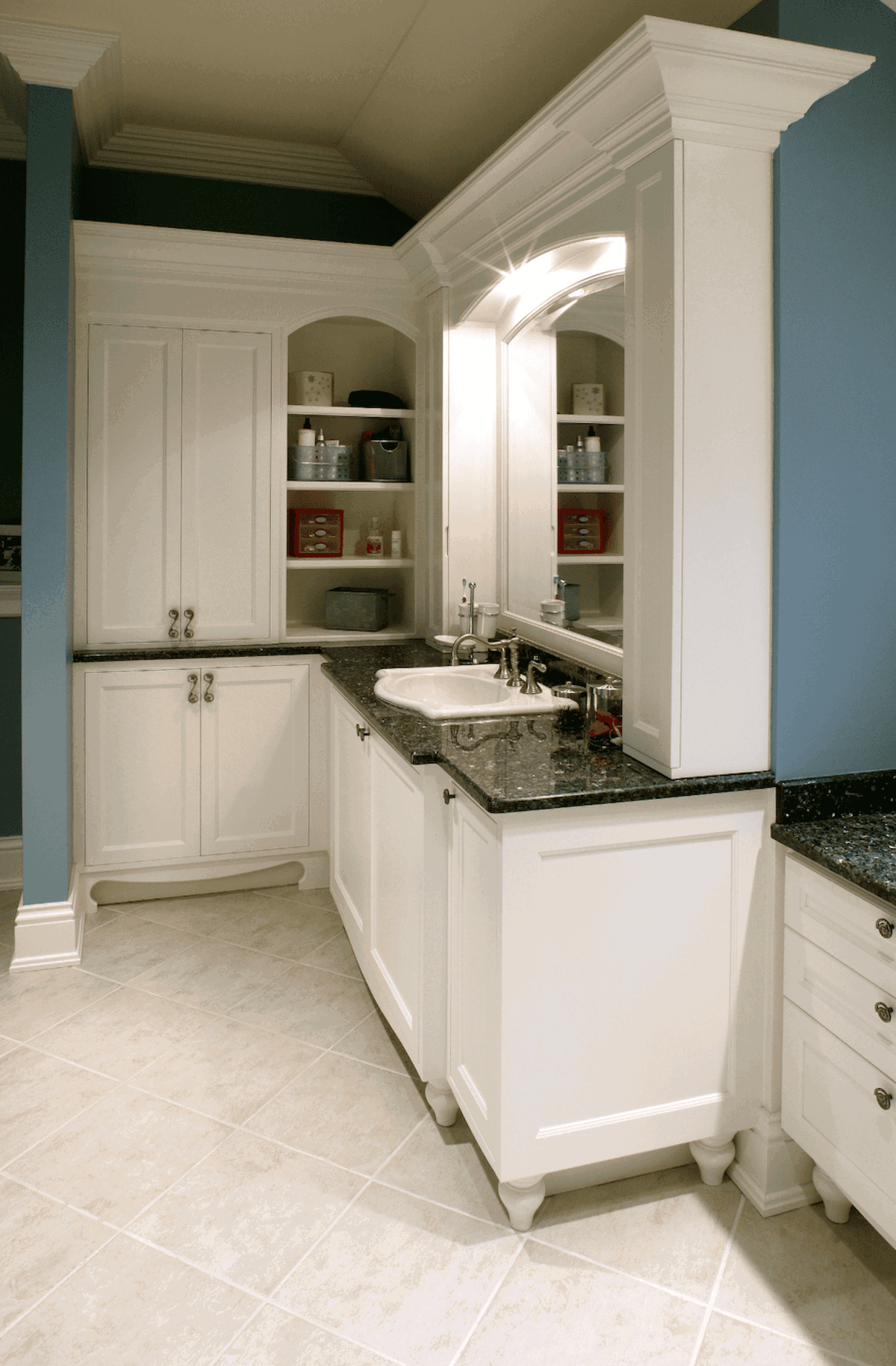 White bathroom cabinetry framed by columns