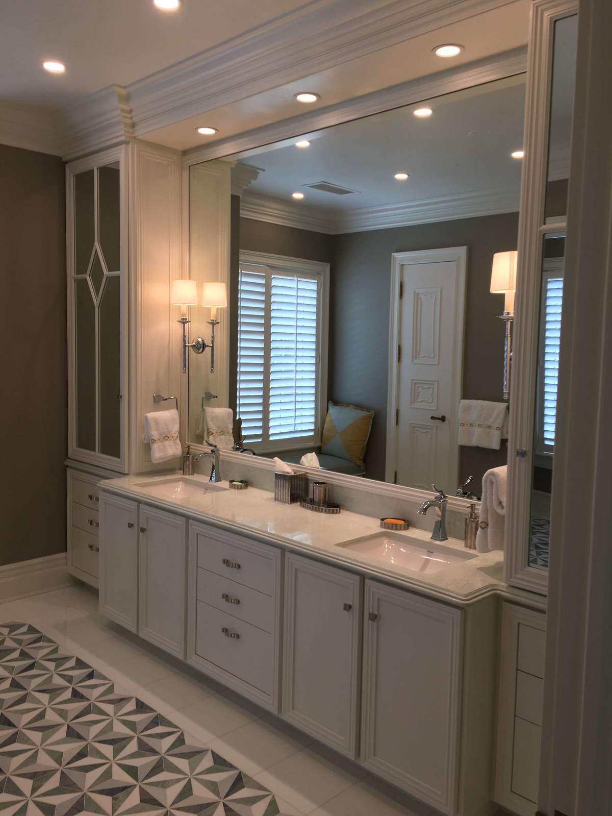 Double vanity with large mirrors and patterned tile floor