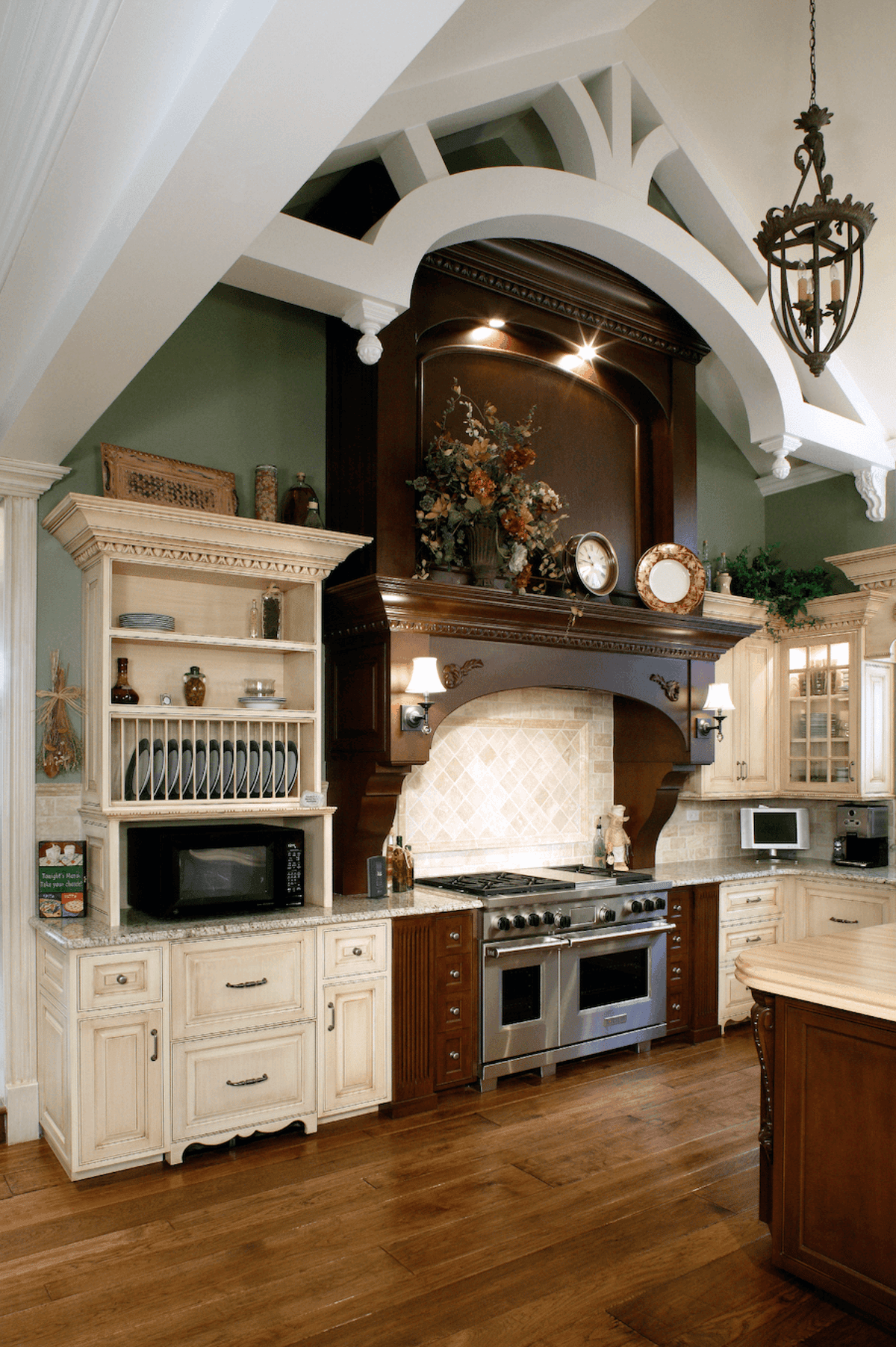 Kitchen range with carved hood and cream cabinetry