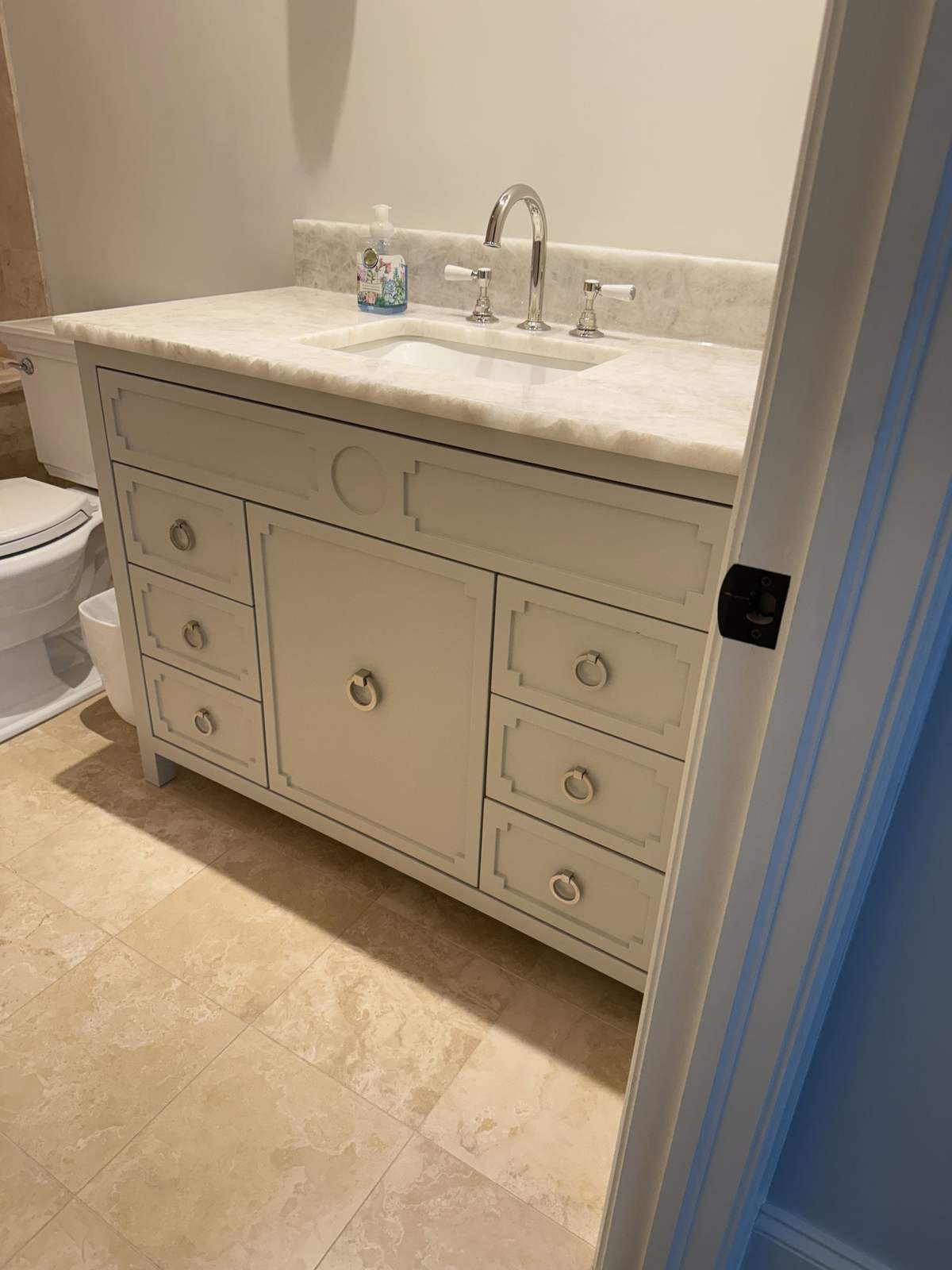 White bathroom vanity with stone countertop