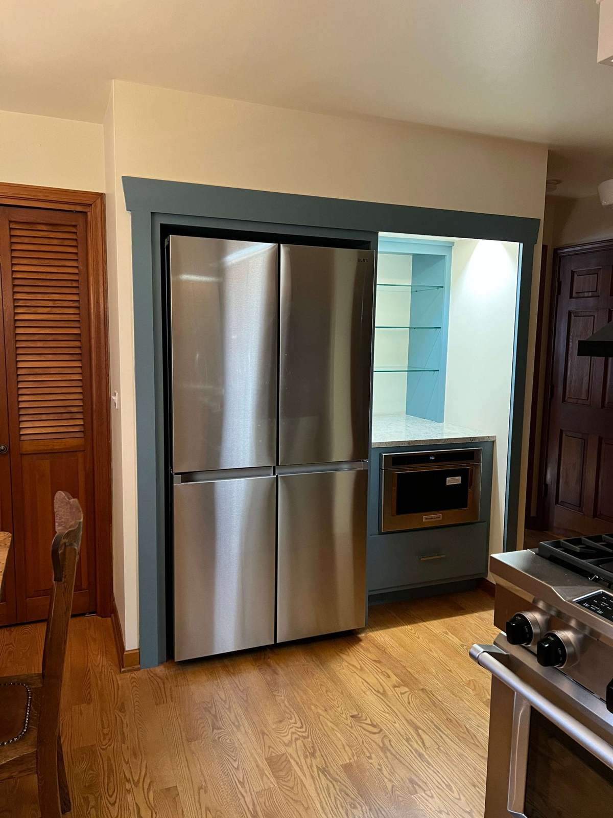Remodeled kitchen appliance wall with stainless refrigerator