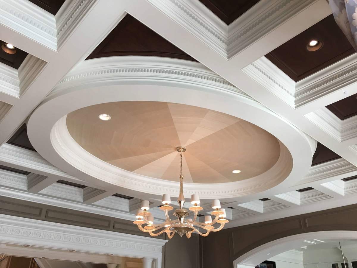 Coffered ceiling with circular detail and chandelier