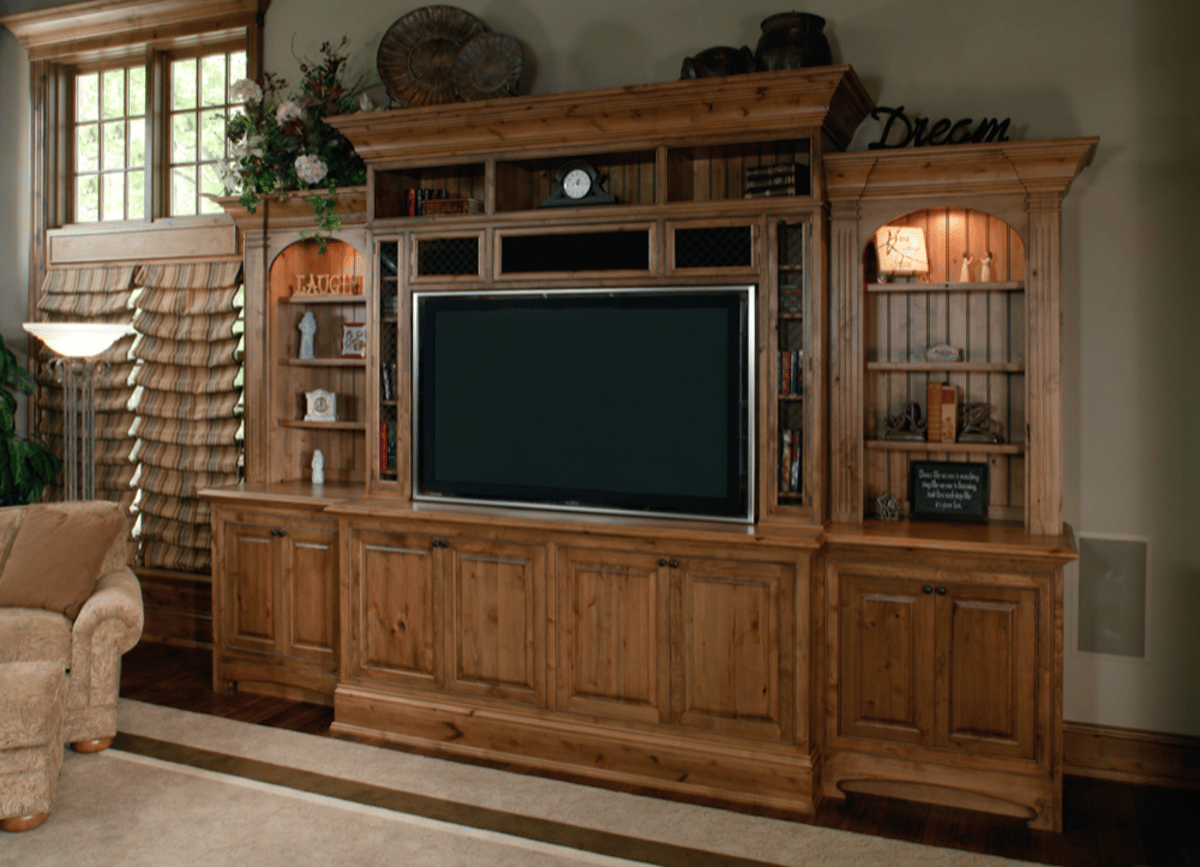 Wood entertainment center with TV and display shelves