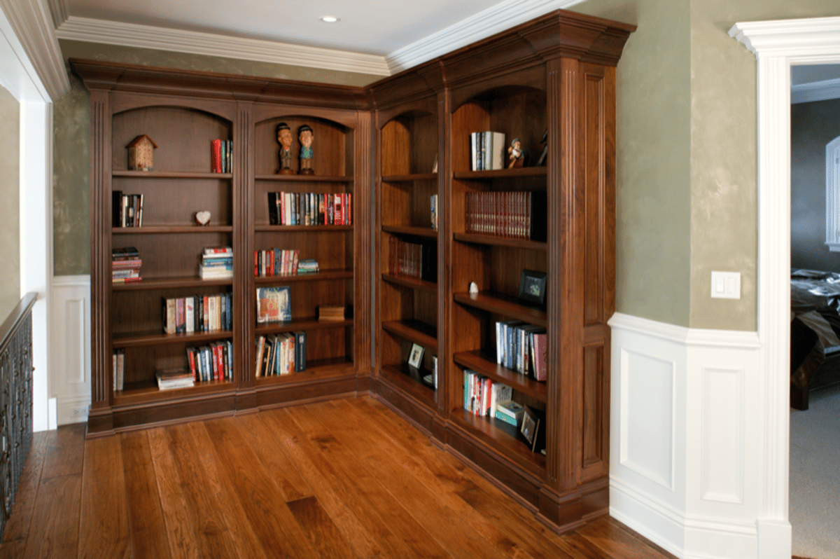 Dark wood library shelves around a room corner