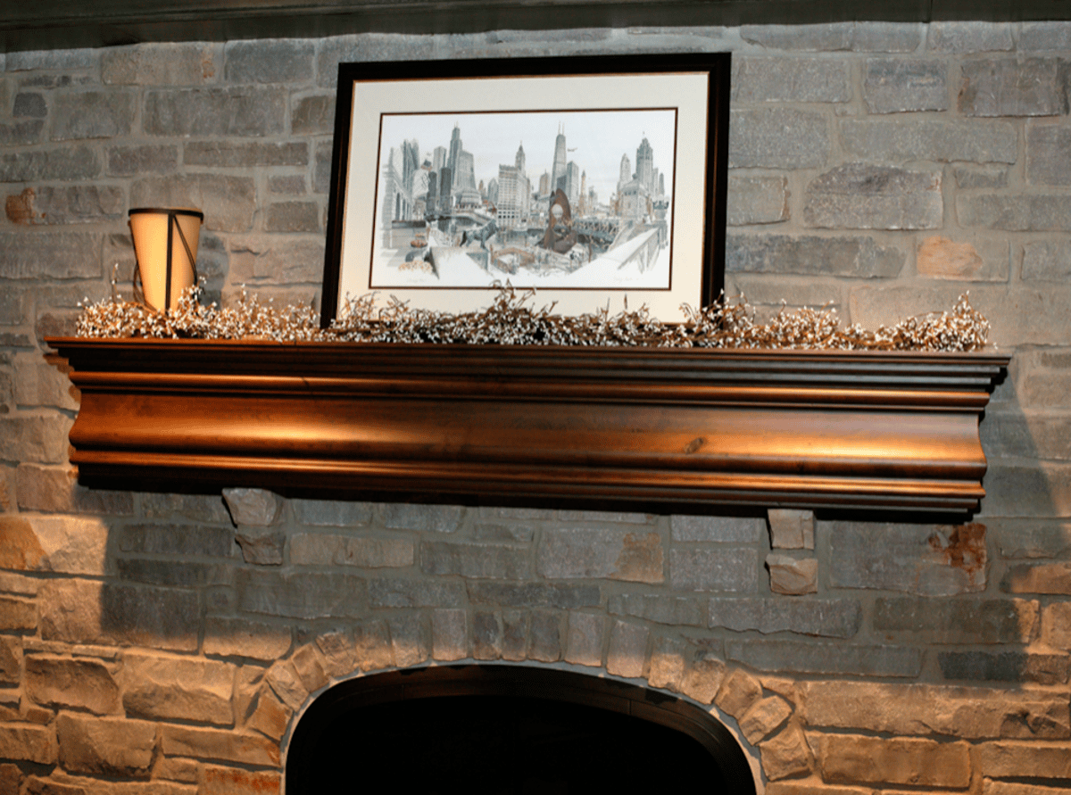 Wood mantel on a stone fireplace