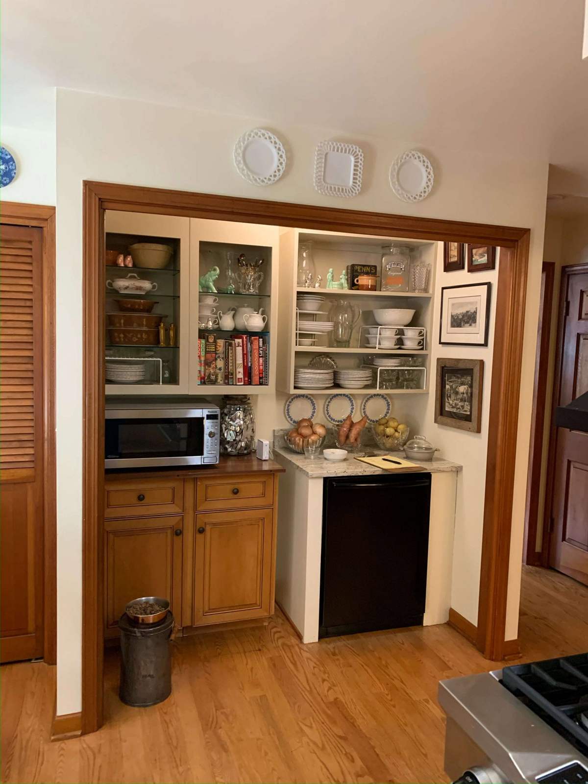 Kitchen before remodeling with display shelves and cabinetry